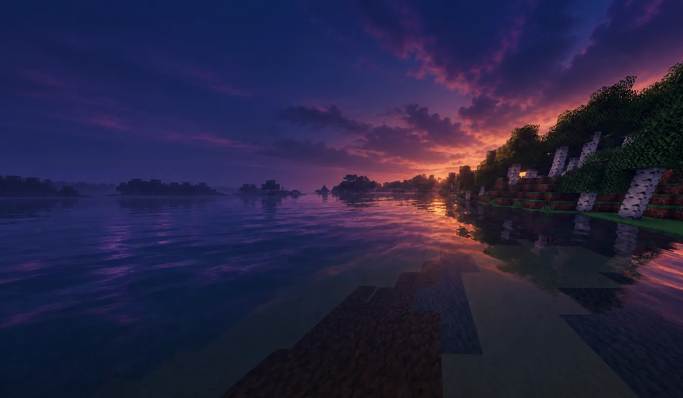 A calm blocky lake surrounded by forest under a violet evening sky